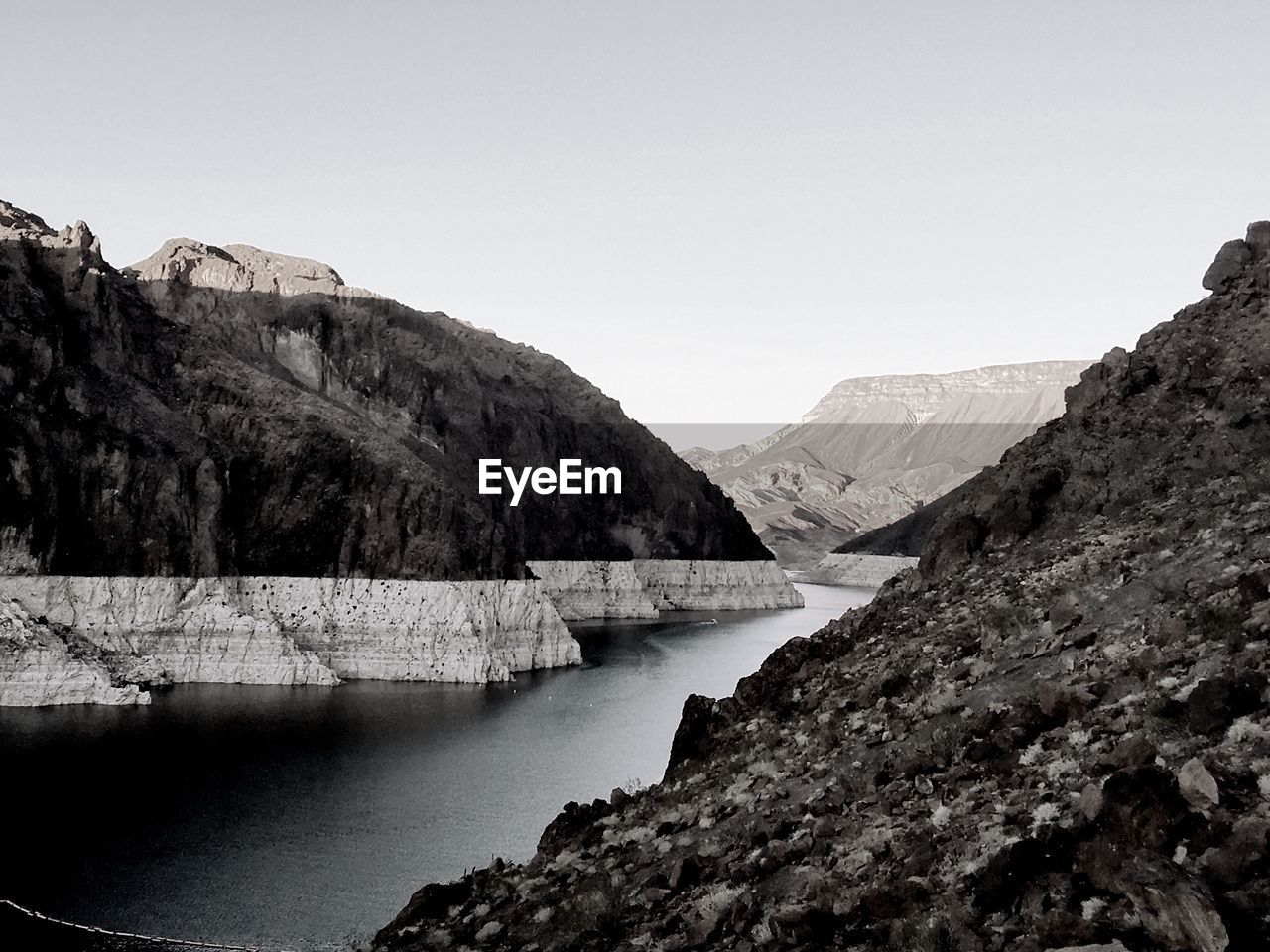 Scenic view of lake and mountains against clear sky