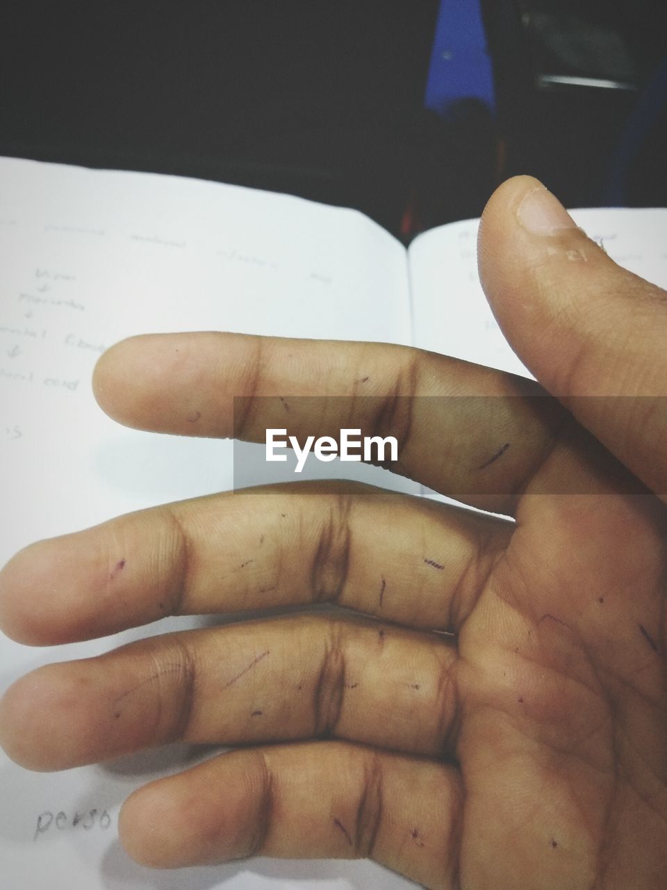 CLOSE-UP OF HANDS ON TABLE