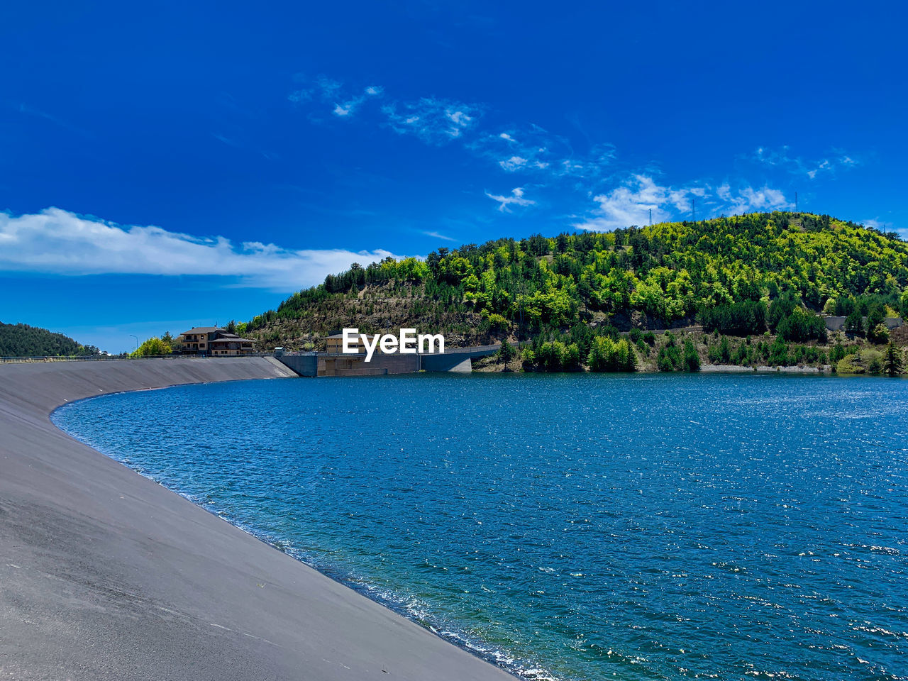 SCENIC VIEW OF BEACH AGAINST BLUE SKY