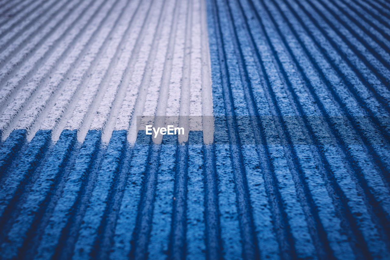 Full frame shot of white and blue parallel striped surface