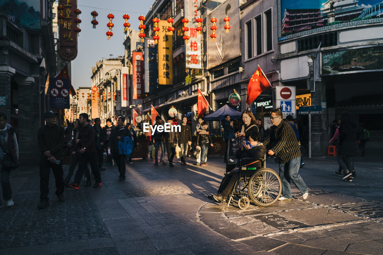 CROWD ON CITY STREET