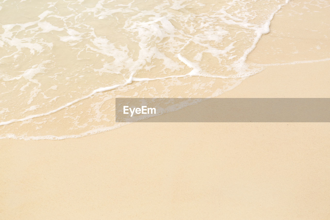 Tropical beach background with soft wave and white sand