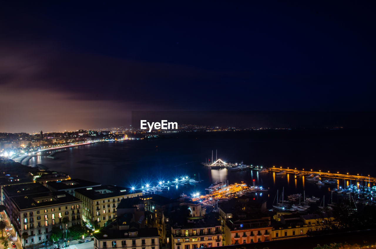 High angle view of city lit up at night