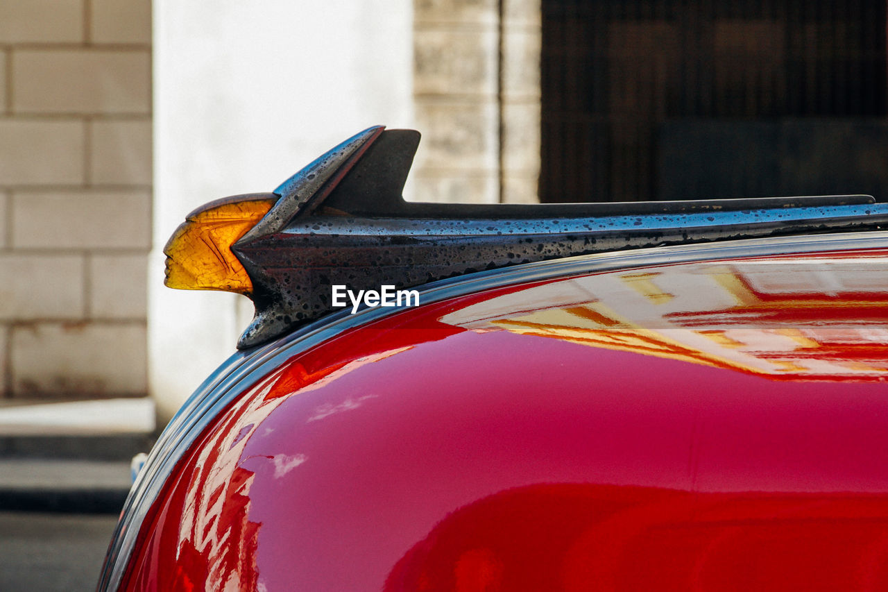 CLOSE-UP OF RED CAR MIRROR