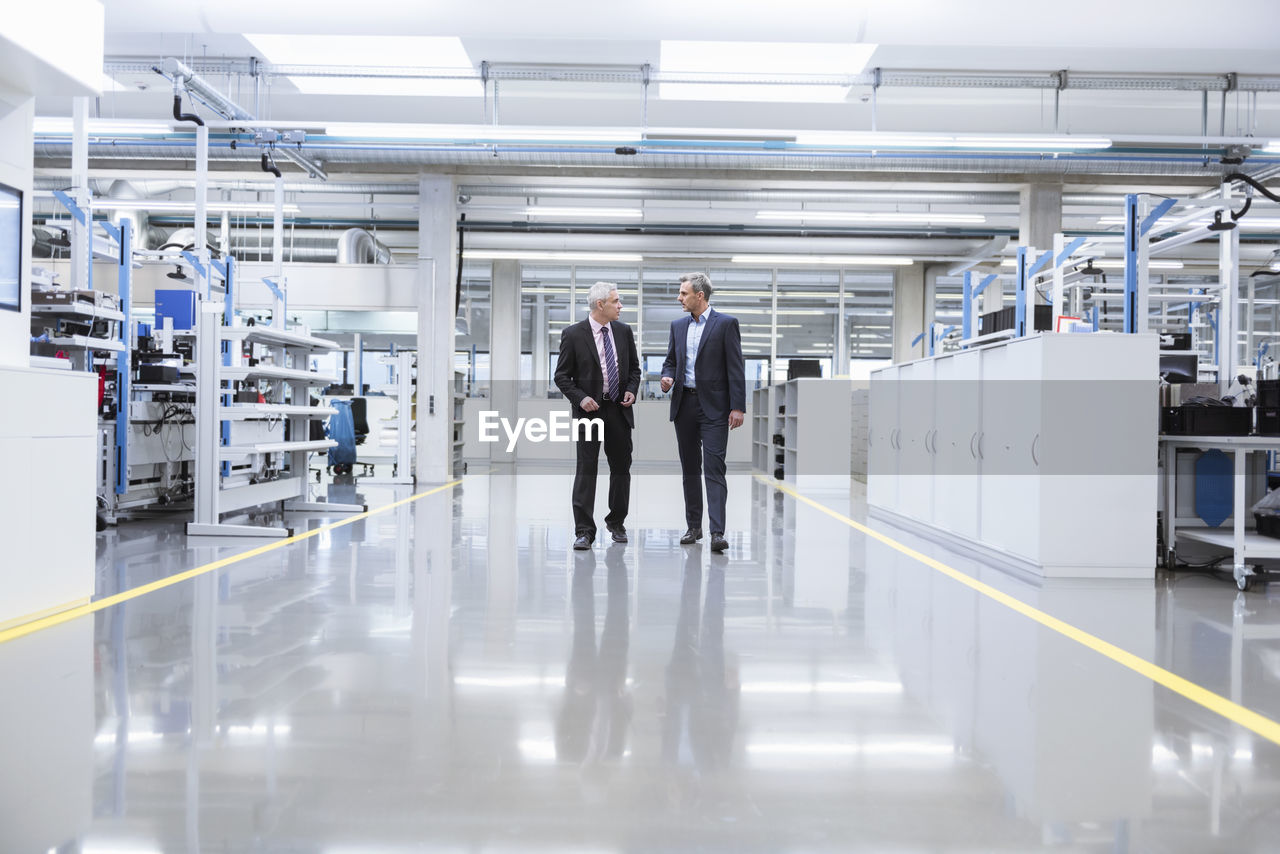 Two mangagers having a meeting at the shop floor of a factory