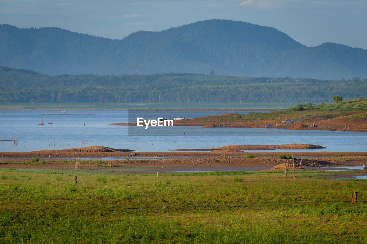 SCENIC VIEW OF LANDSCAPE AND MOUNTAINS AGAINST SKY