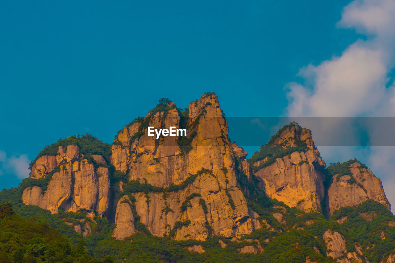 Low angle view of rock formation against sky