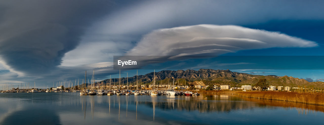 Panoramic view of lake by buildings against sky