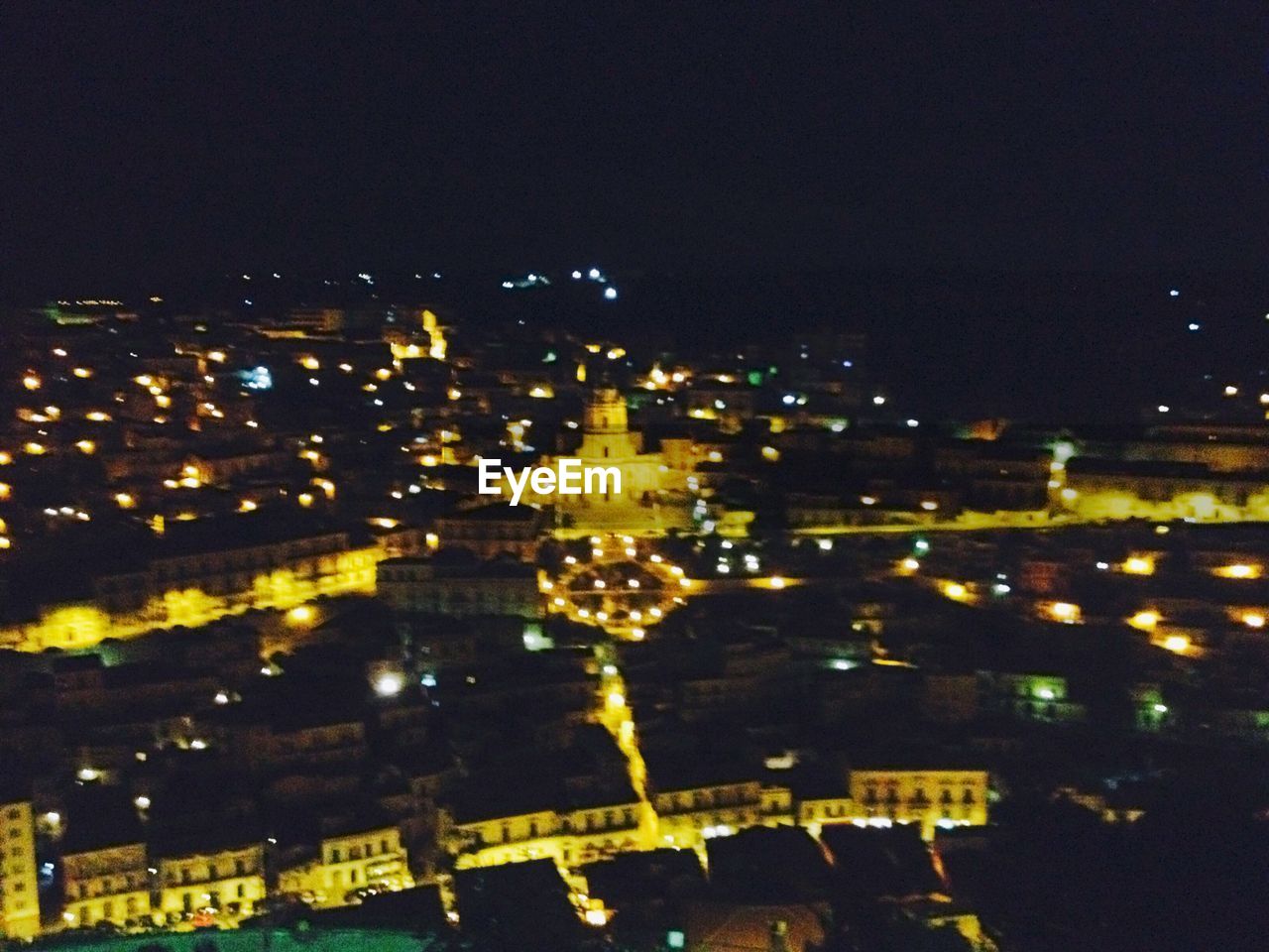 VIEW OF ILLUMINATED CITY AT NIGHT