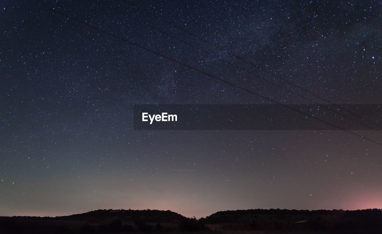 LOW ANGLE VIEW OF STARS AGAINST STAR FIELD