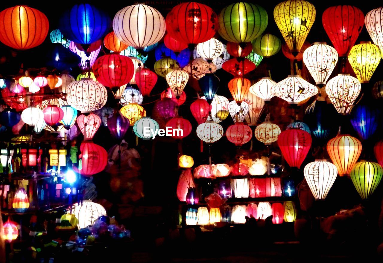 LOW ANGLE VIEW OF LANTERN HANGING AT NIGHT