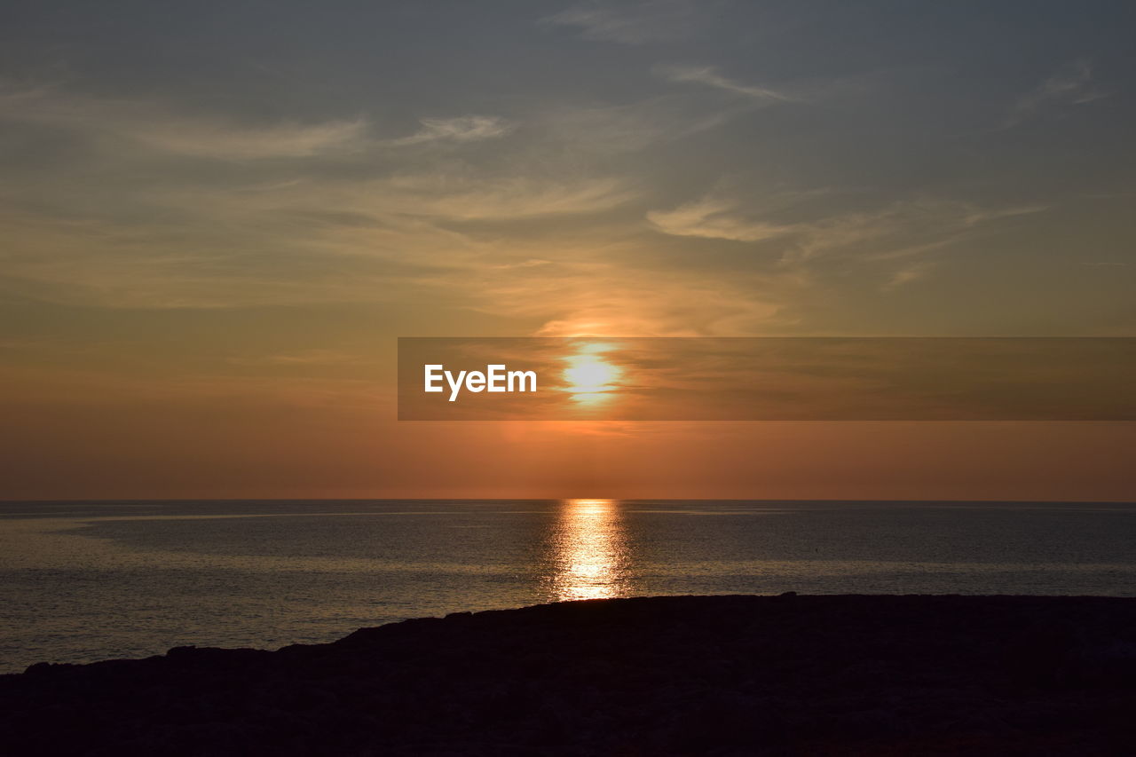 scenic view of sea against orange sky