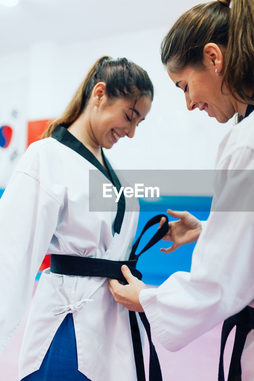 Young women wearing belt during taekwondo practice