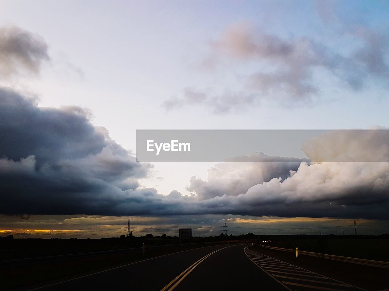 ROAD PASSING THROUGH LANDSCAPE AGAINST SKY