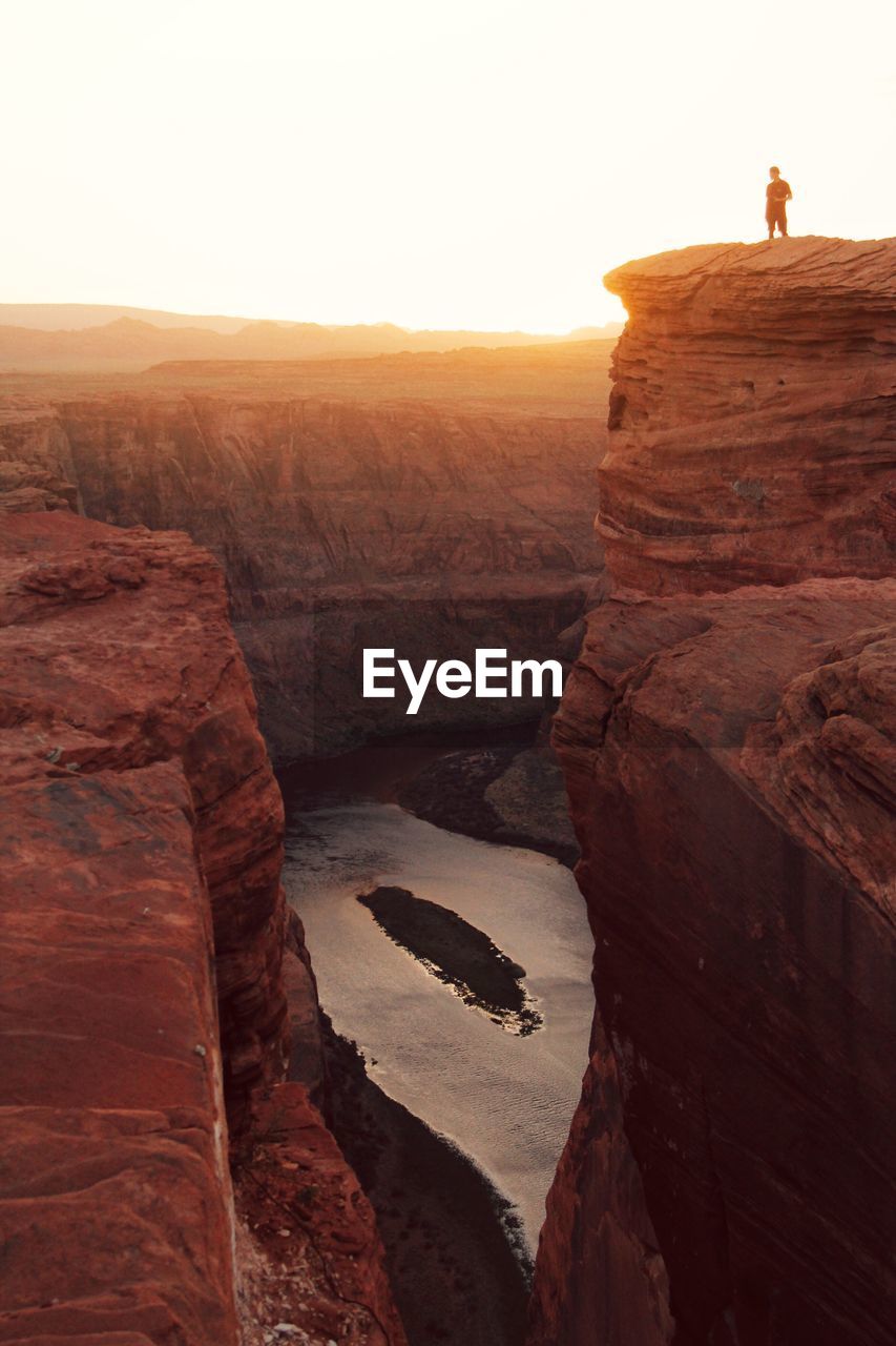 Low angle view of man standing on rock formation