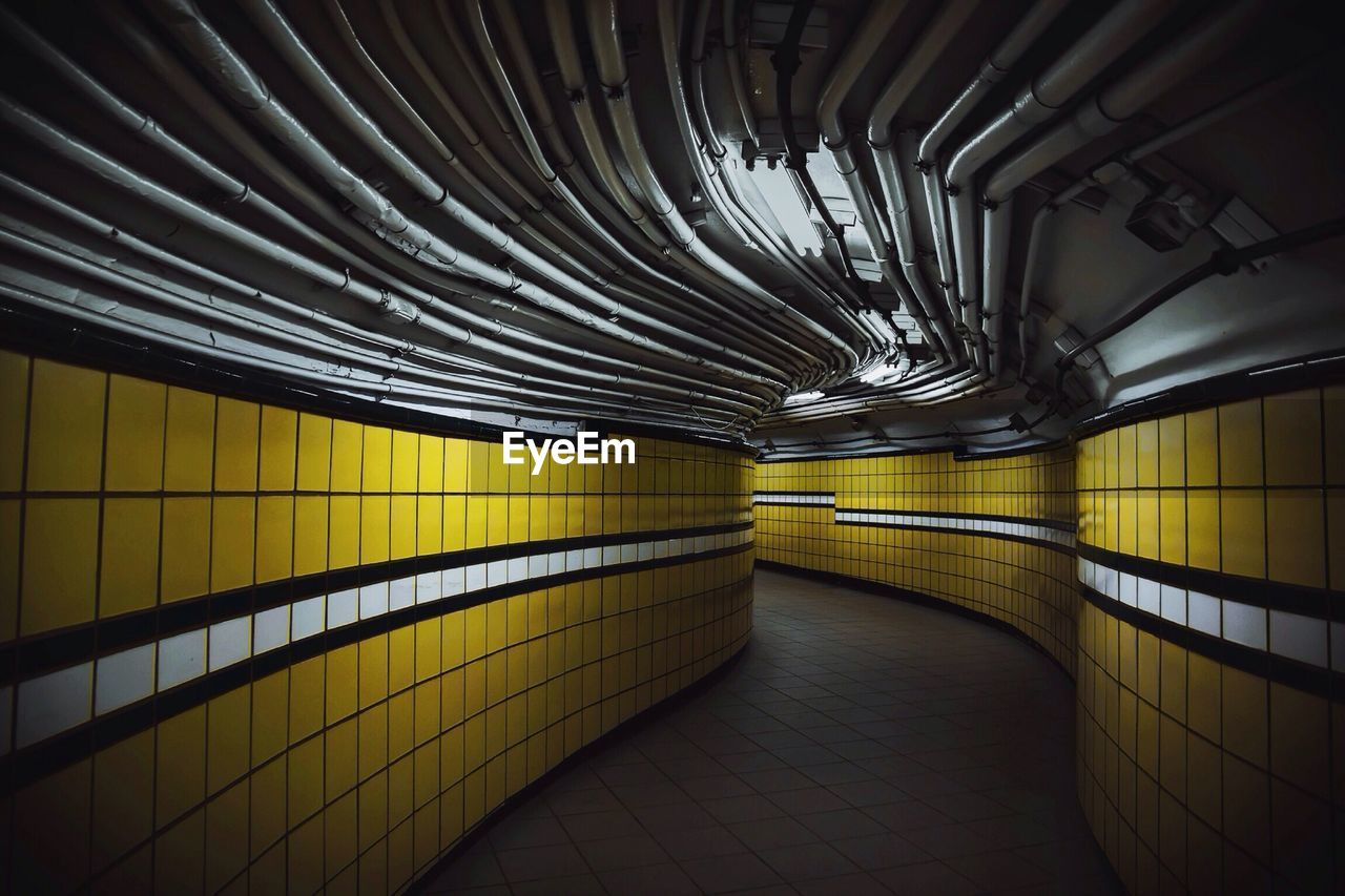 Corridor with yellow tiled walls