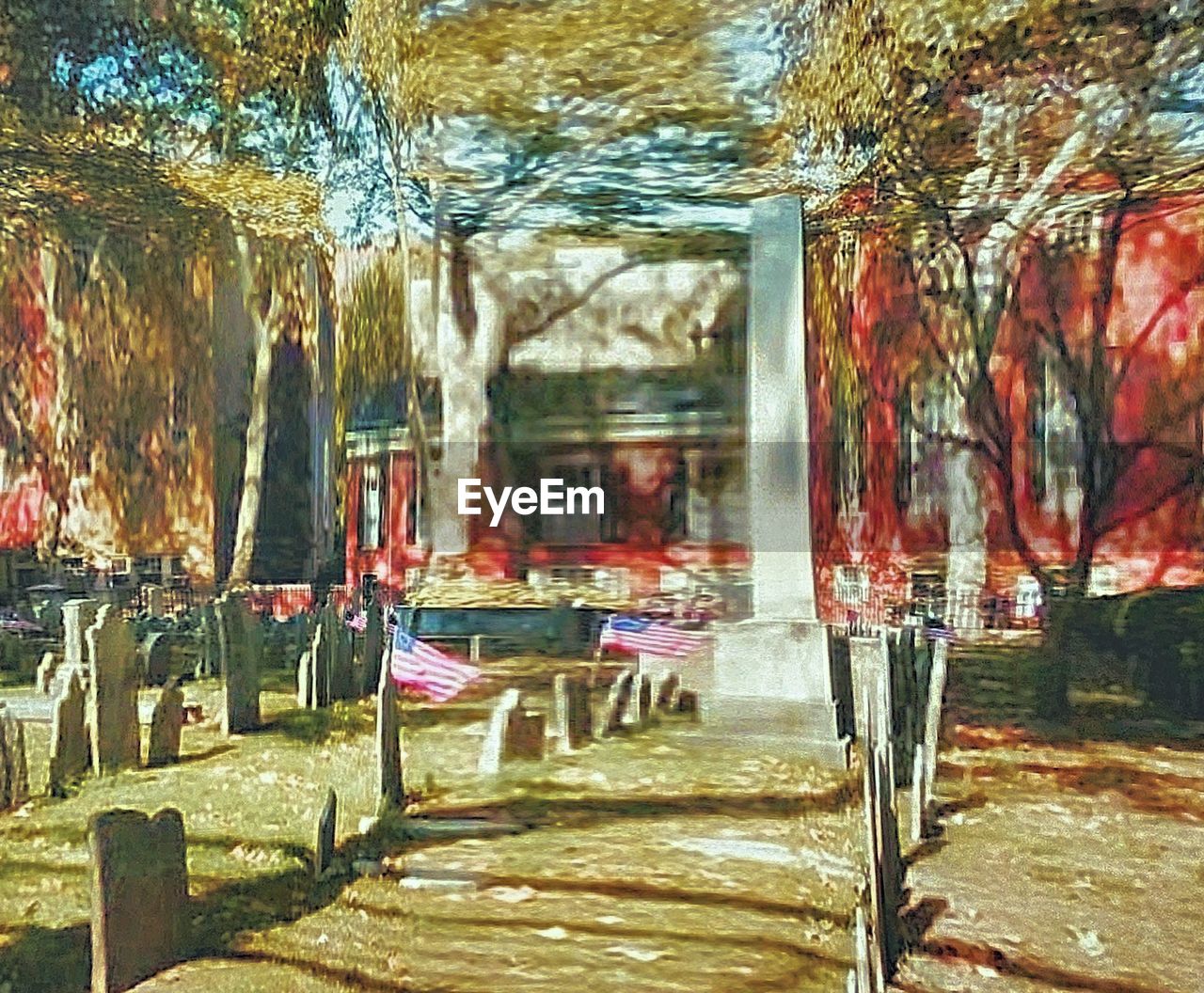 EMPTY CHAIRS AND TABLE AGAINST TREES AND BUILDING