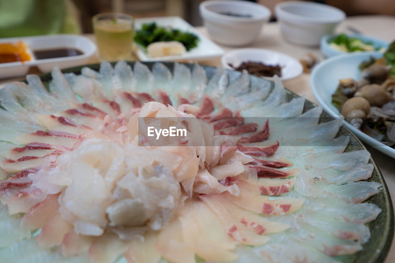 Close-up of chopped raw fish in bowl on table