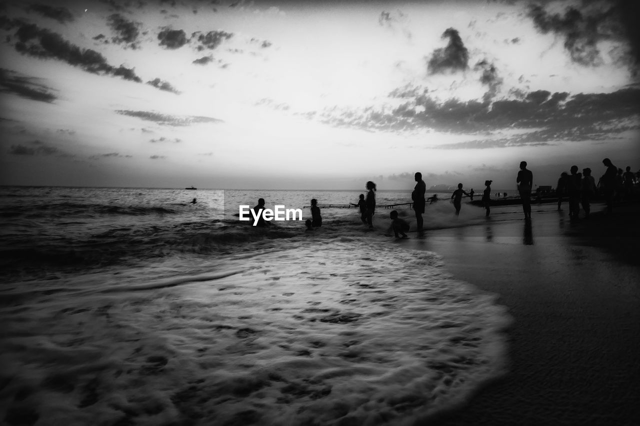 Silhouette people on beach