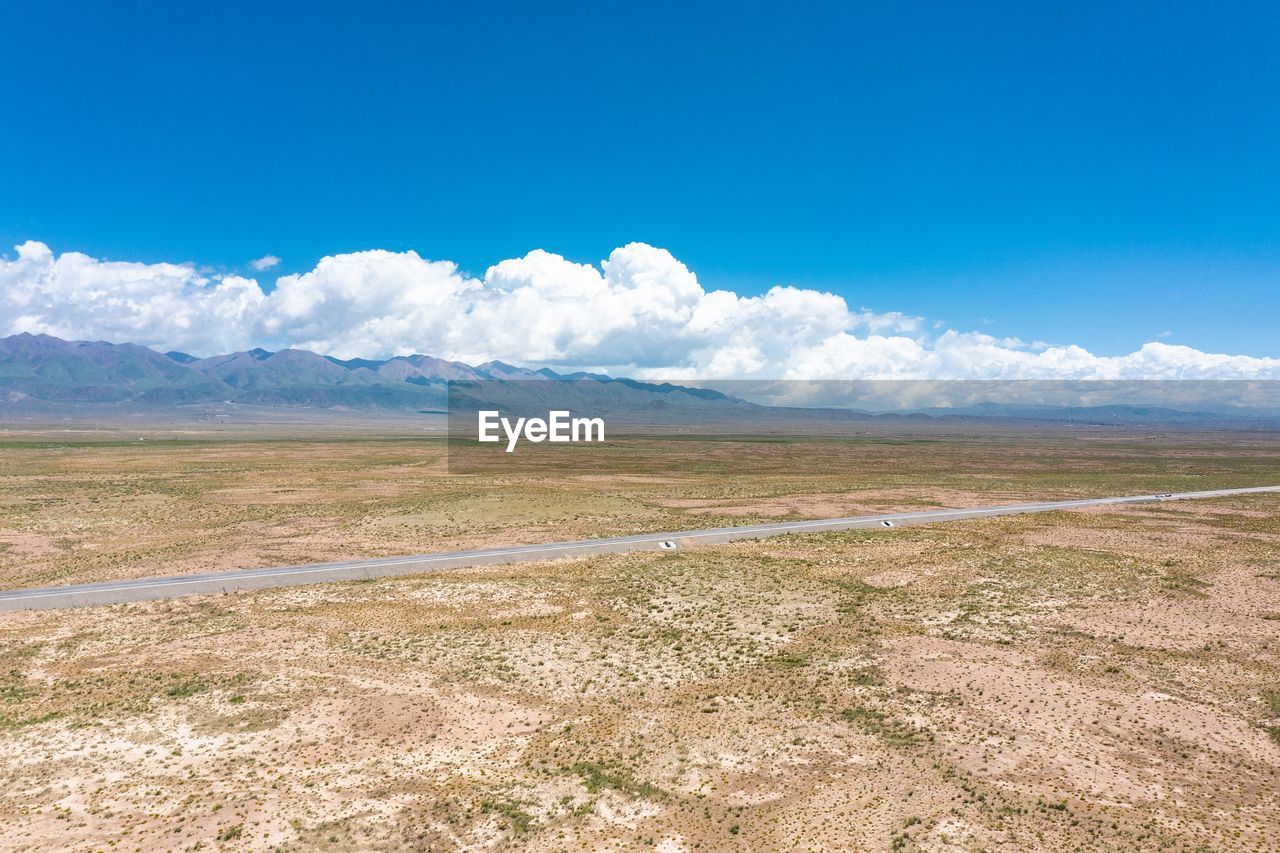 SCENIC VIEW OF LANDSCAPE AND MOUNTAINS AGAINST SKY