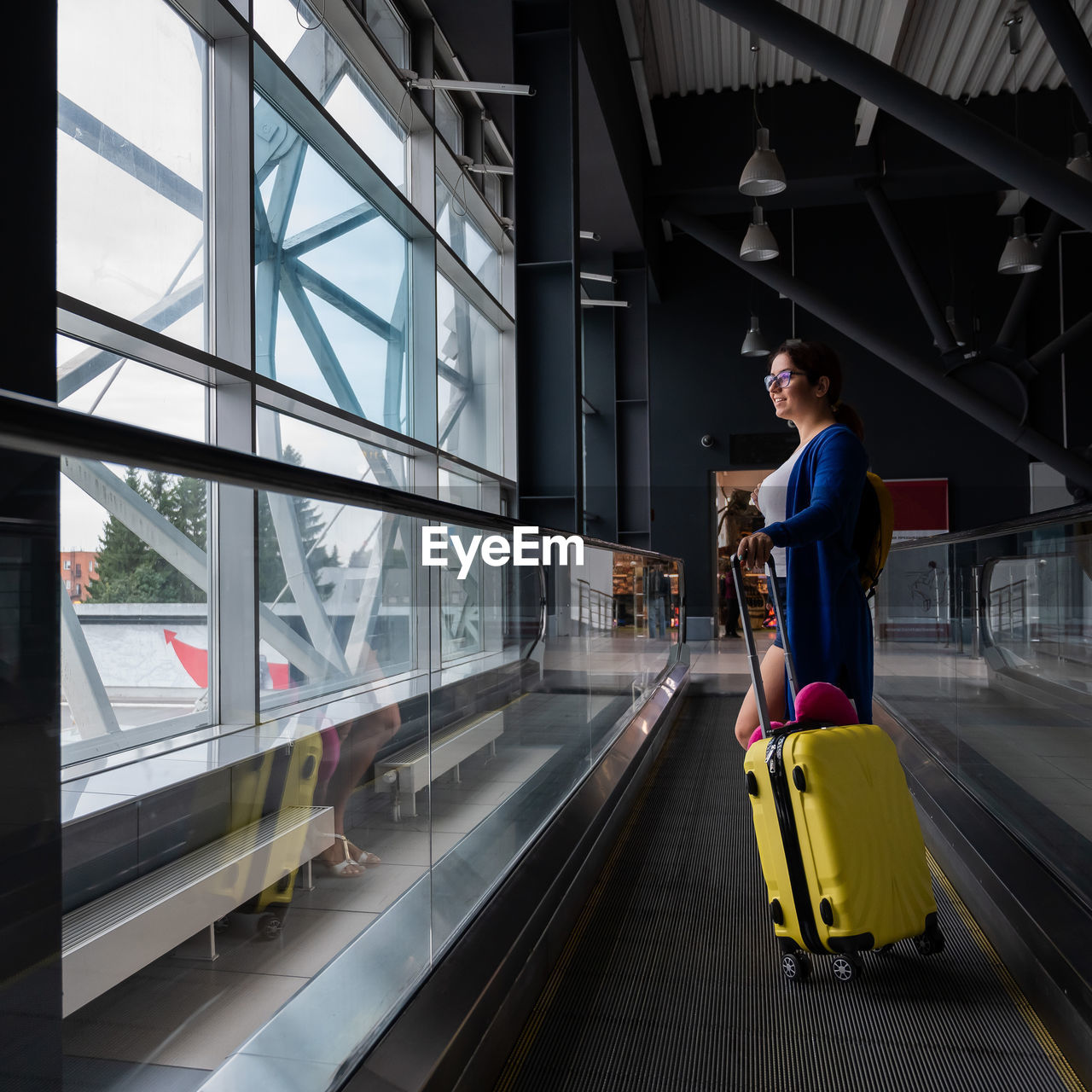 FULL LENGTH OF MAN STANDING ON RAILROAD STATION PLATFORM