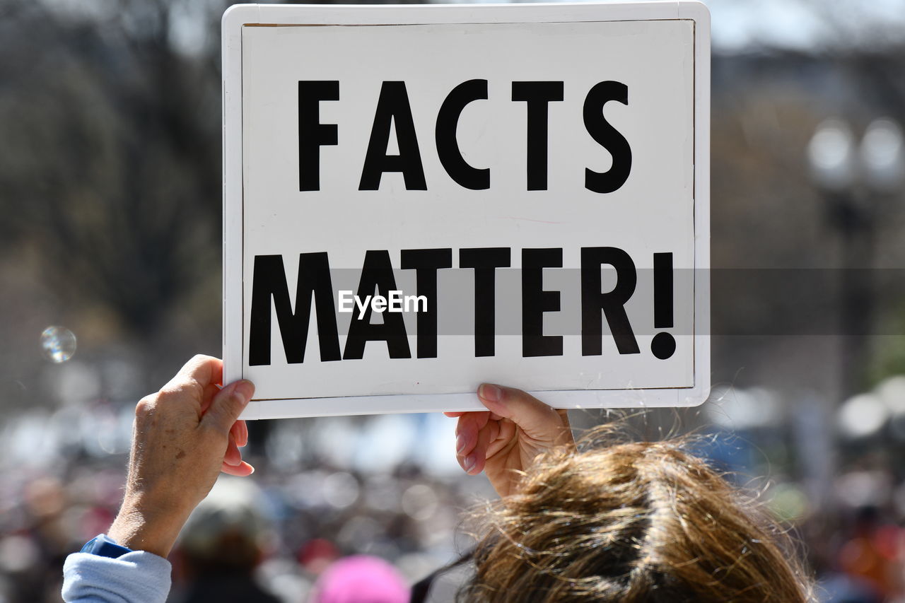 Close-up of woman holding placard during protest