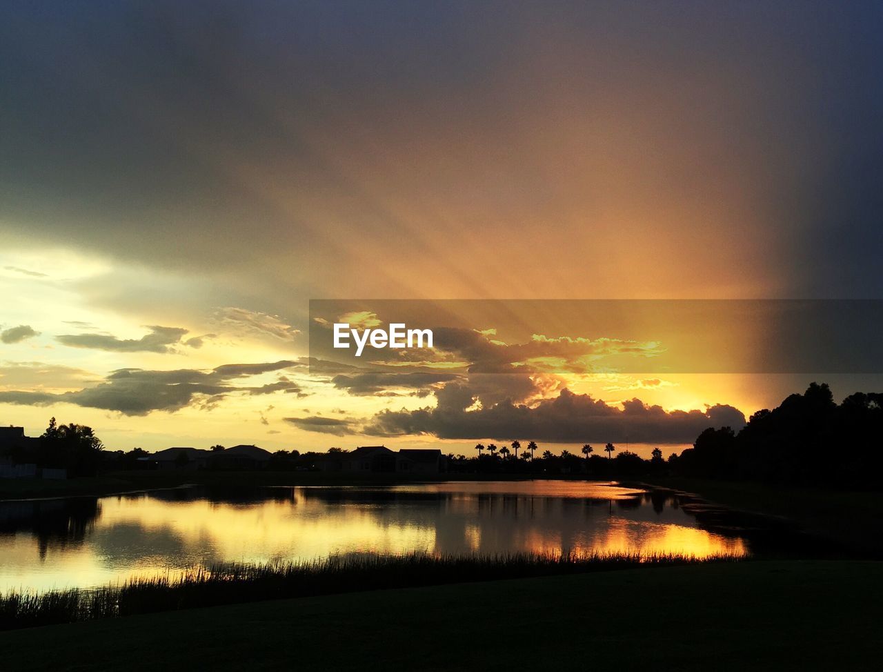 Scenic view of lake against sky during sunset