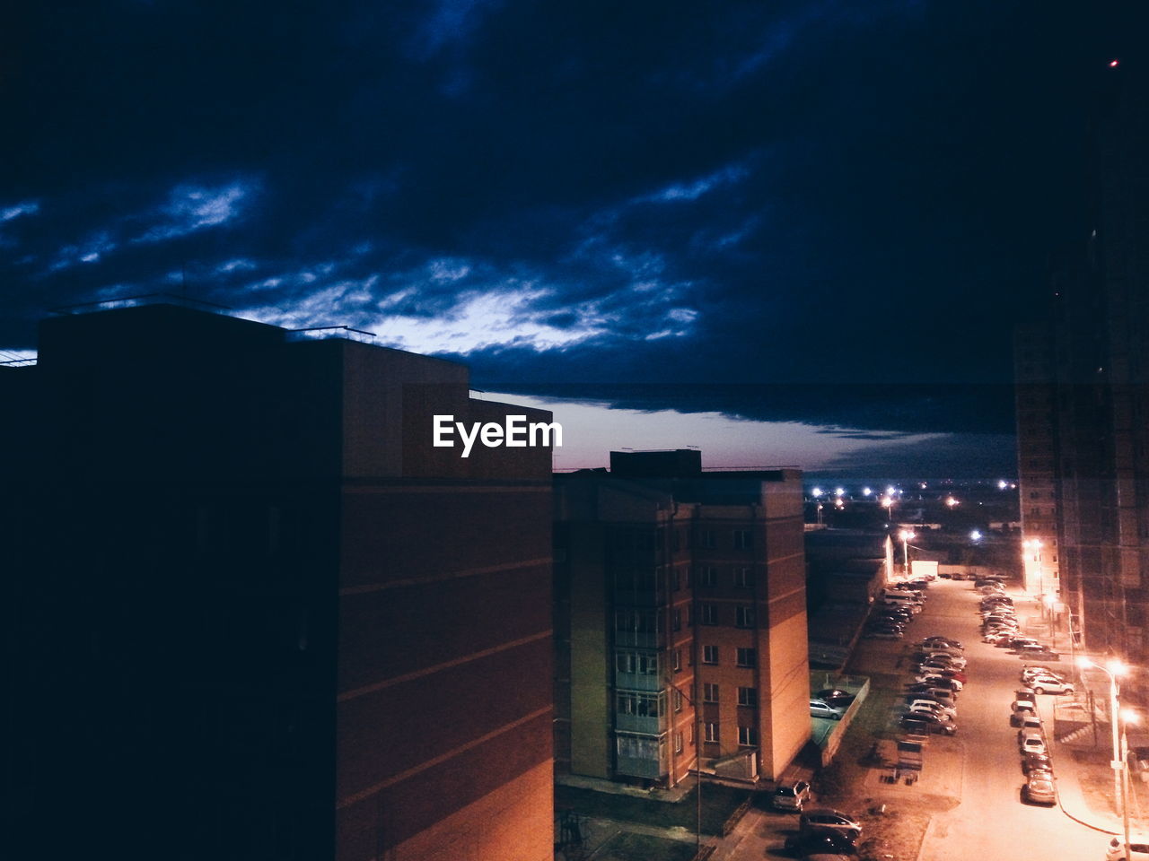 ILLUMINATED BUILDINGS AGAINST SKY AT NIGHT