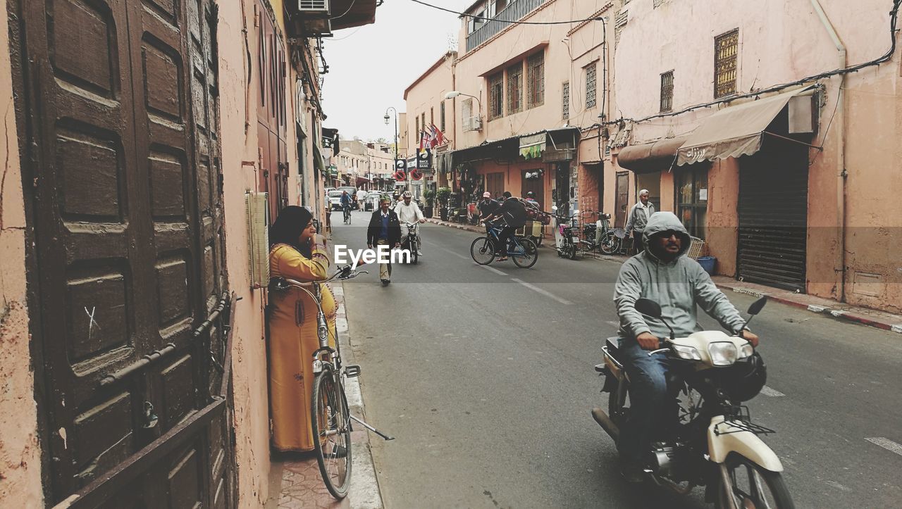 PEOPLE RIDING BICYCLES ON ROAD