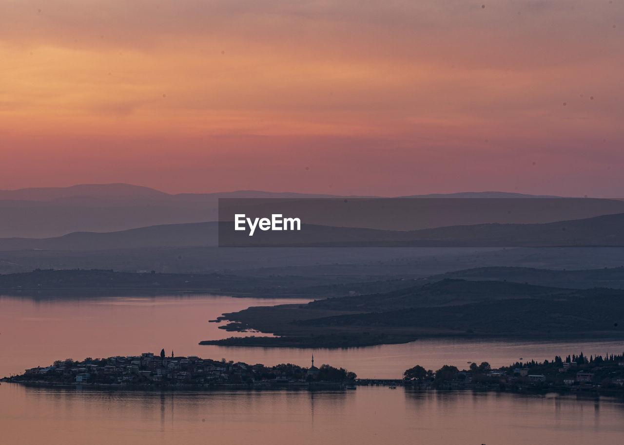 Scenic view of lake against romantic sky at sunset