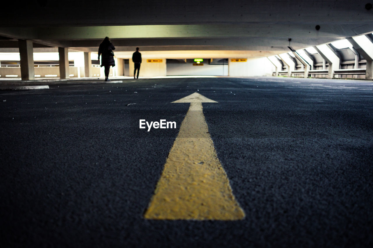 Rear view of people walking in parking lot