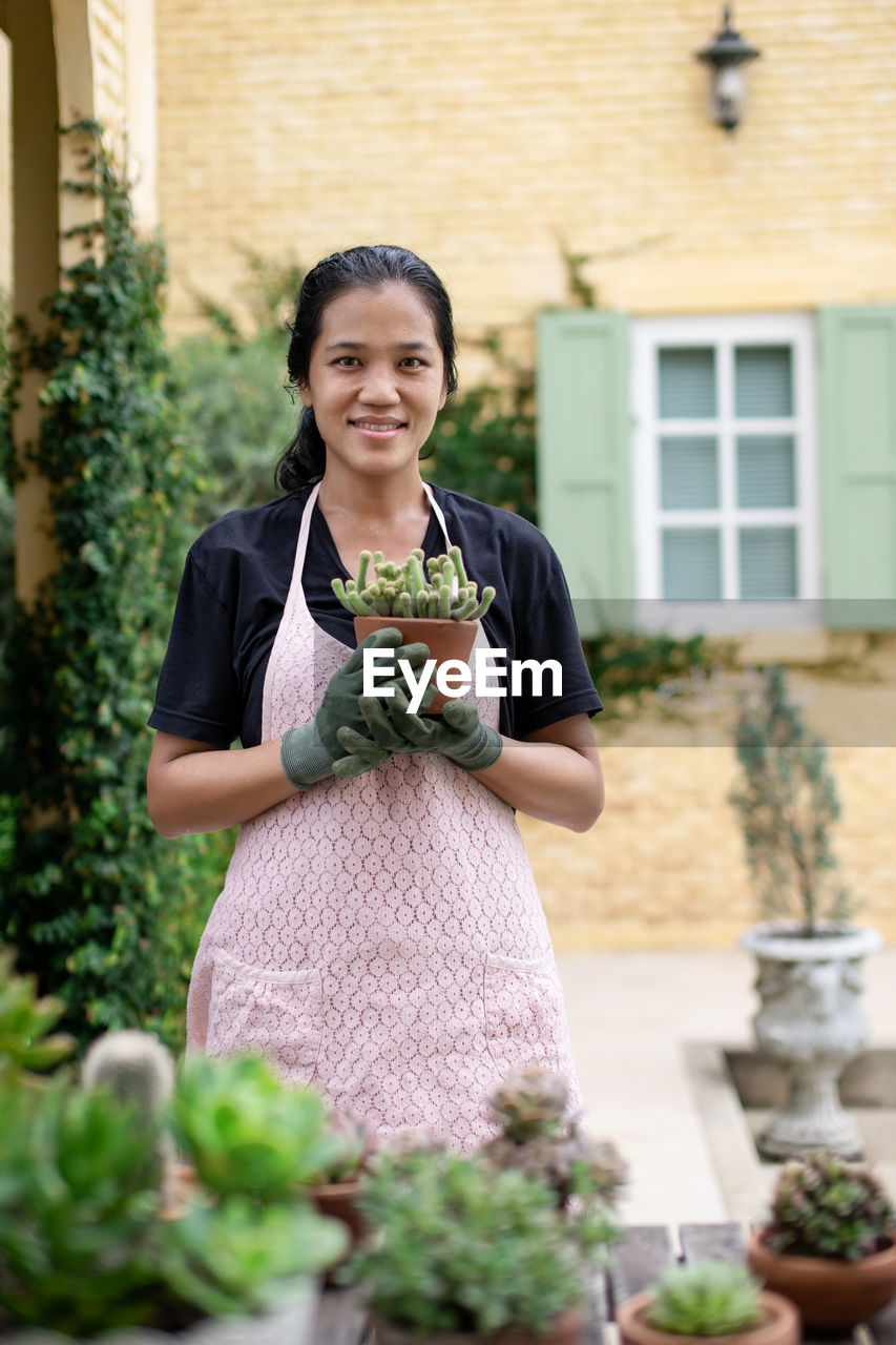 Portrait of smiling young woman standing outdoors