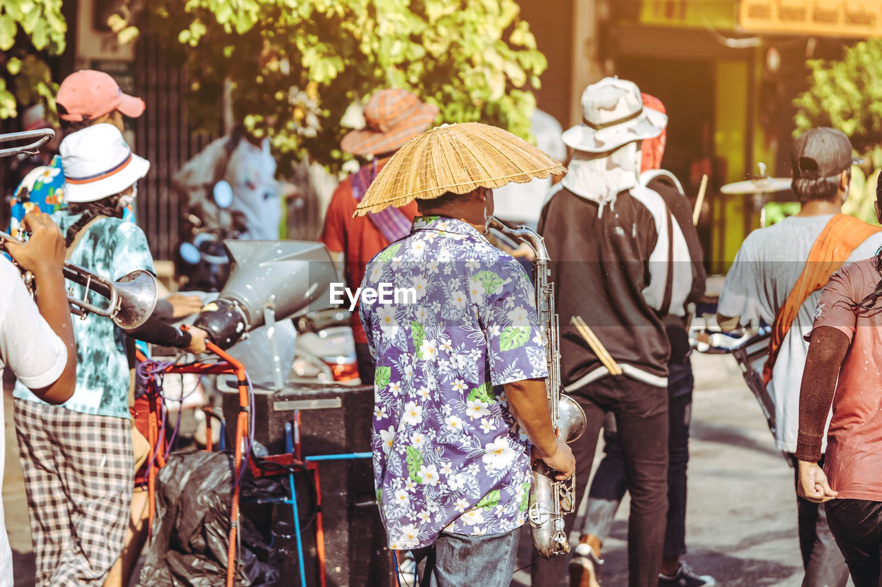 GROUP OF PEOPLE WALKING IN STREET