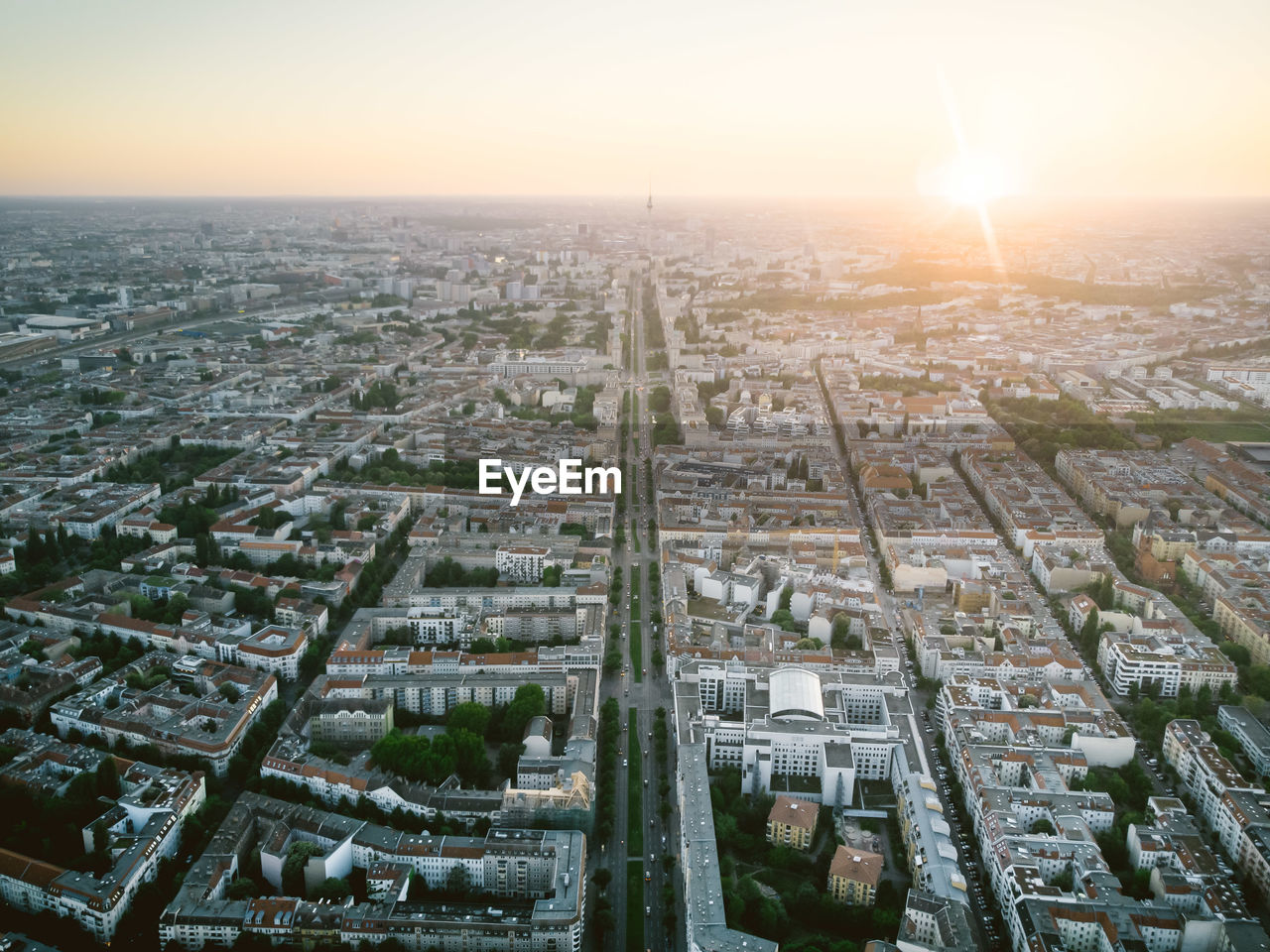 HIGH ANGLE VIEW OF BUILDINGS AGAINST SKY AT SUNSET