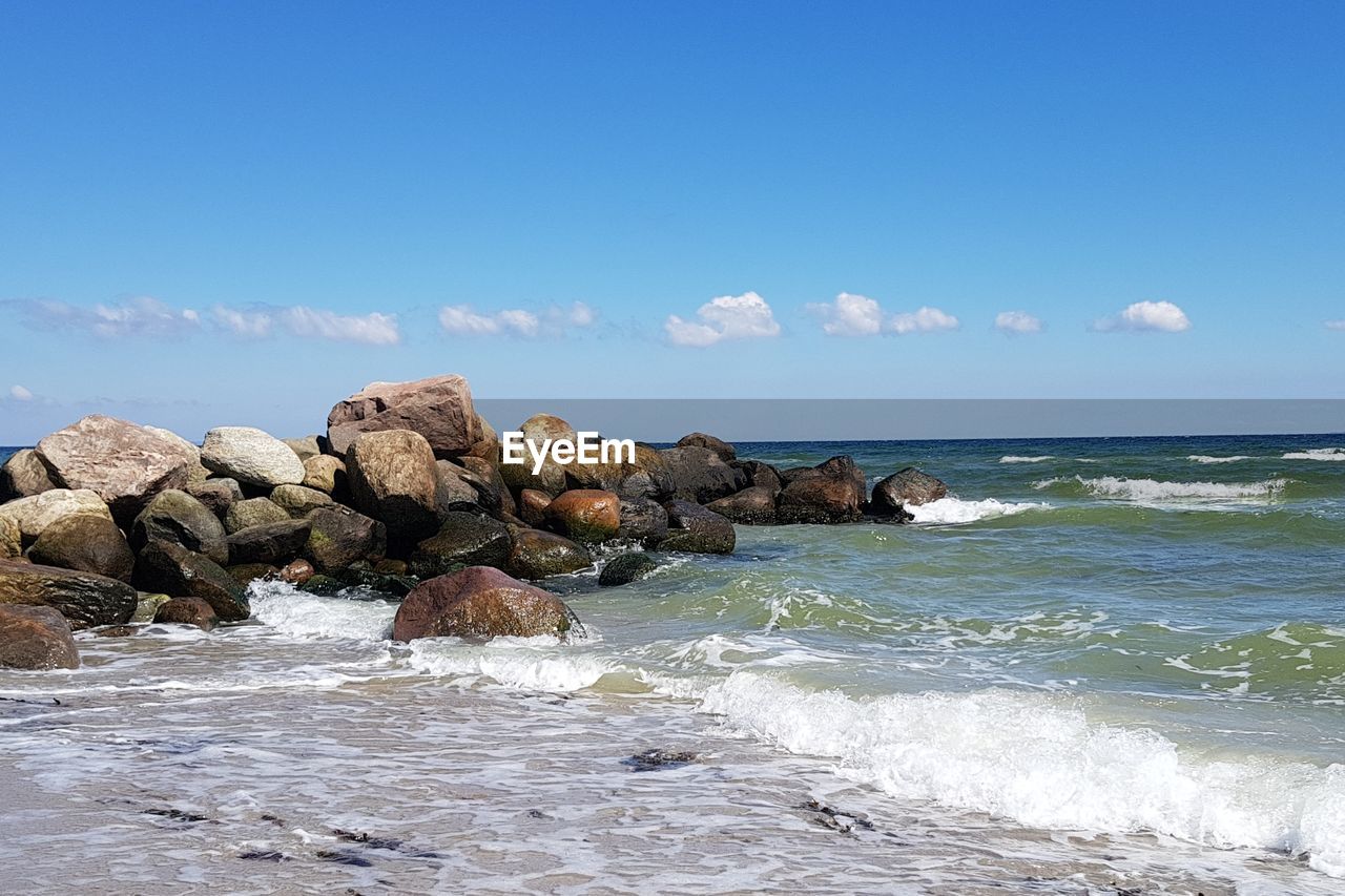 Scenic view of sea against blue sky