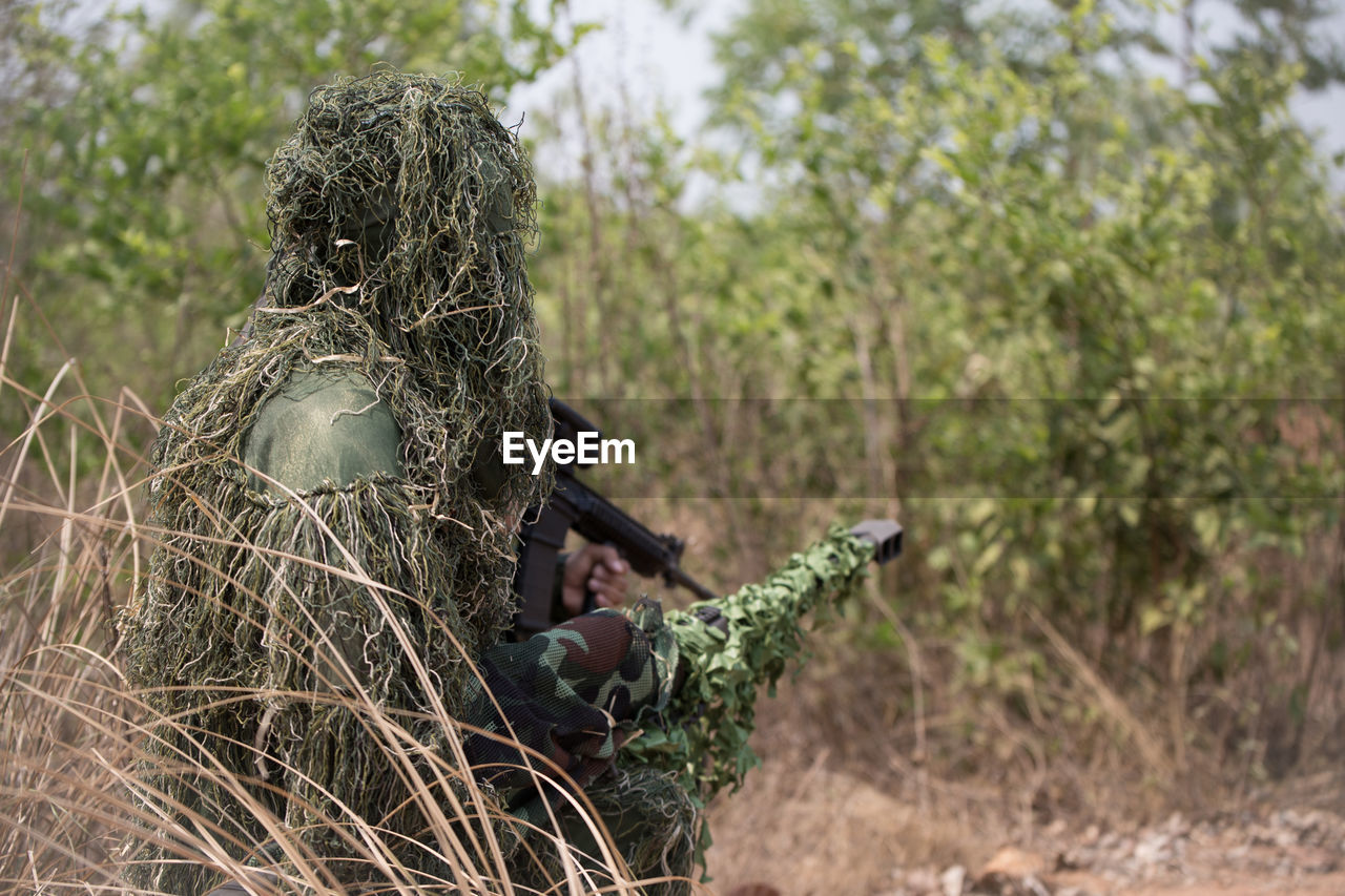 Army soldiers with rifle in forest