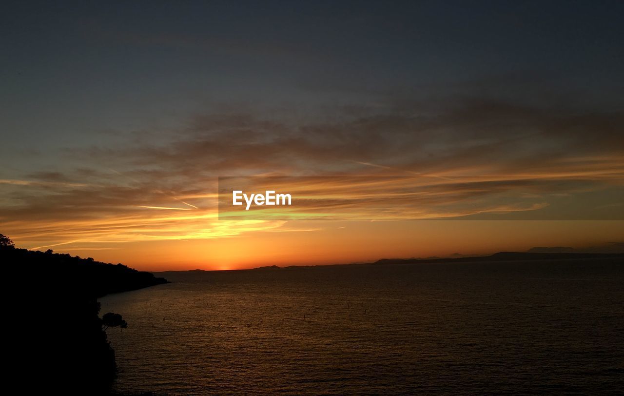 SCENIC VIEW OF SEA DURING SUNSET