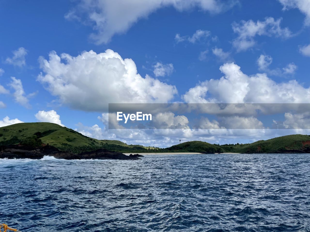 water, sky, cloud, scenics - nature, sea, nature, beauty in nature, mountain, environment, travel, landscape, blue, no people, travel destinations, land, horizon, tranquil scene, tranquility, day, body of water, outdoors, shore, tourism, coast, vehicle, ocean, beach, trip, vacation, holiday, coastline, idyllic, bay, non-urban scene, summer, island