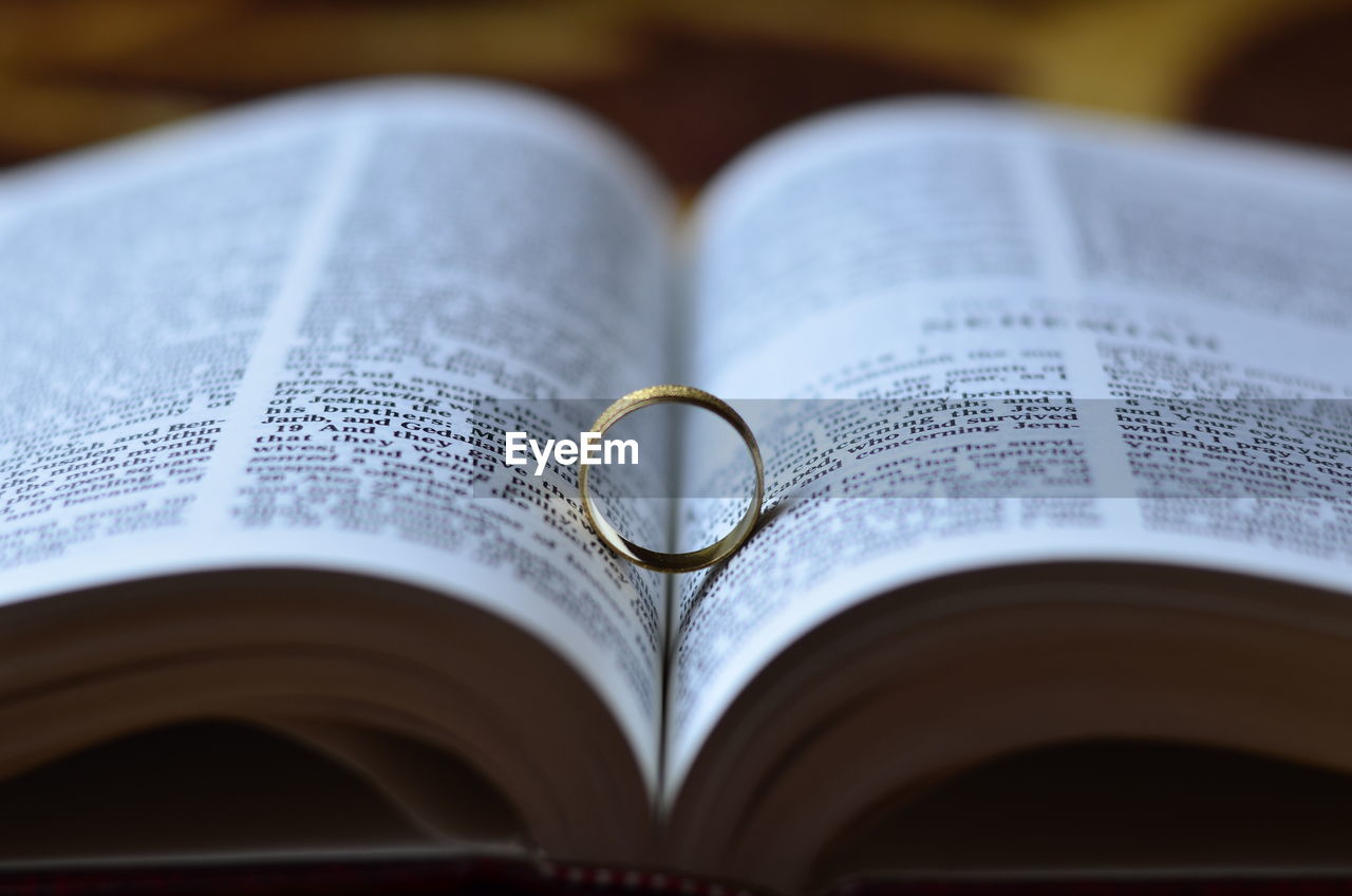 Close-up of ring in open book