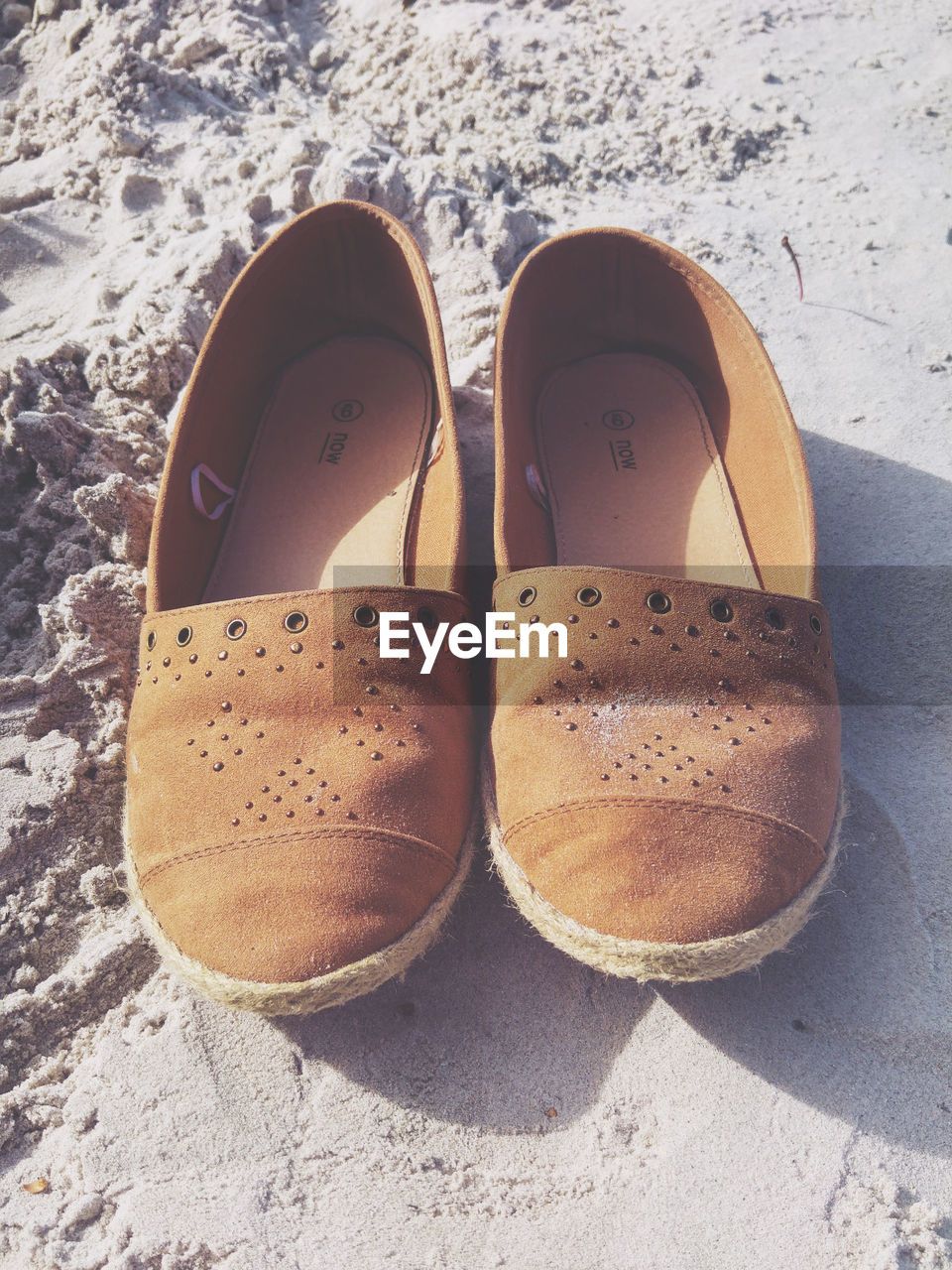 High angle view of brown shoes at beach