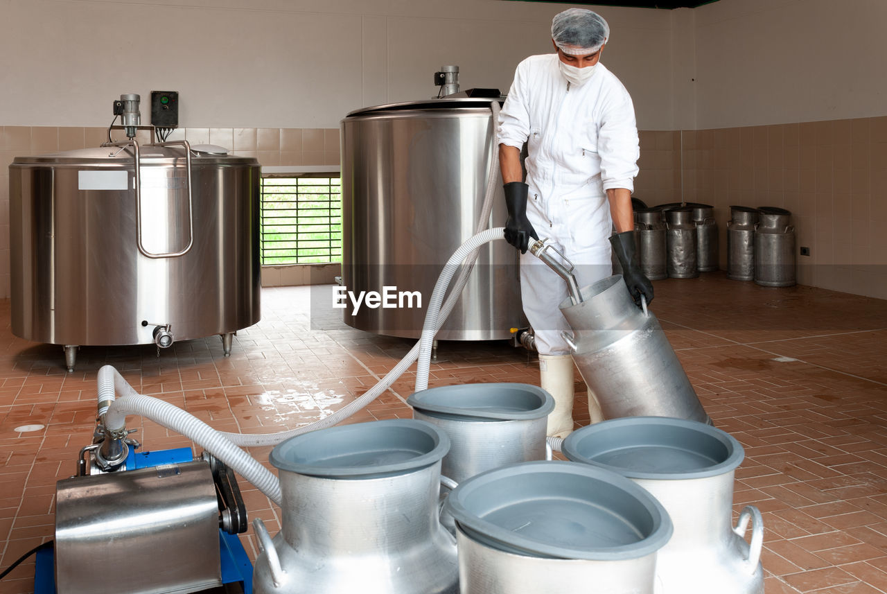 MAN WORKING AT KITCHEN