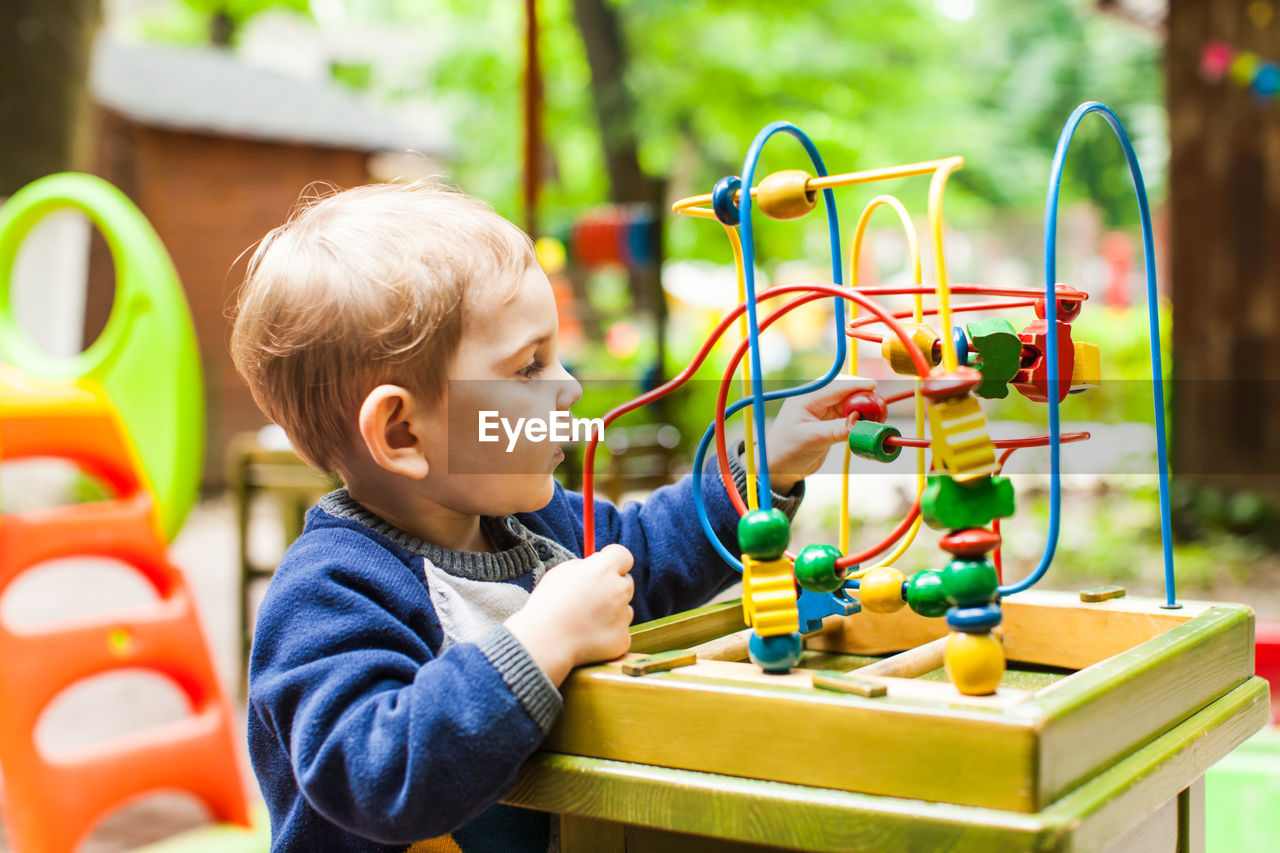 Boy playing with toy toys