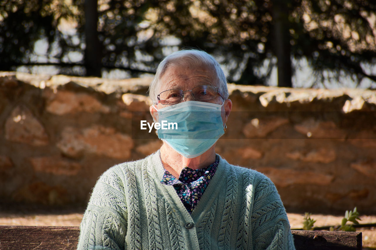 Close-up portrait of an older woman wearing a mask person