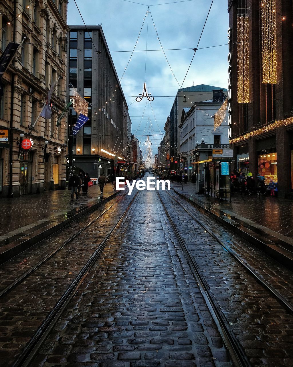 Railroad tracks amidst buildings in city against sky