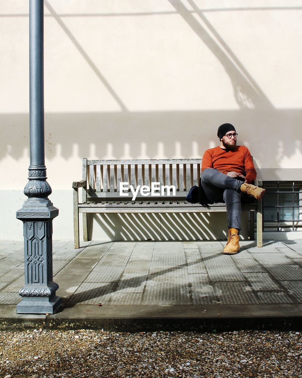 Full length of man sitting on bench