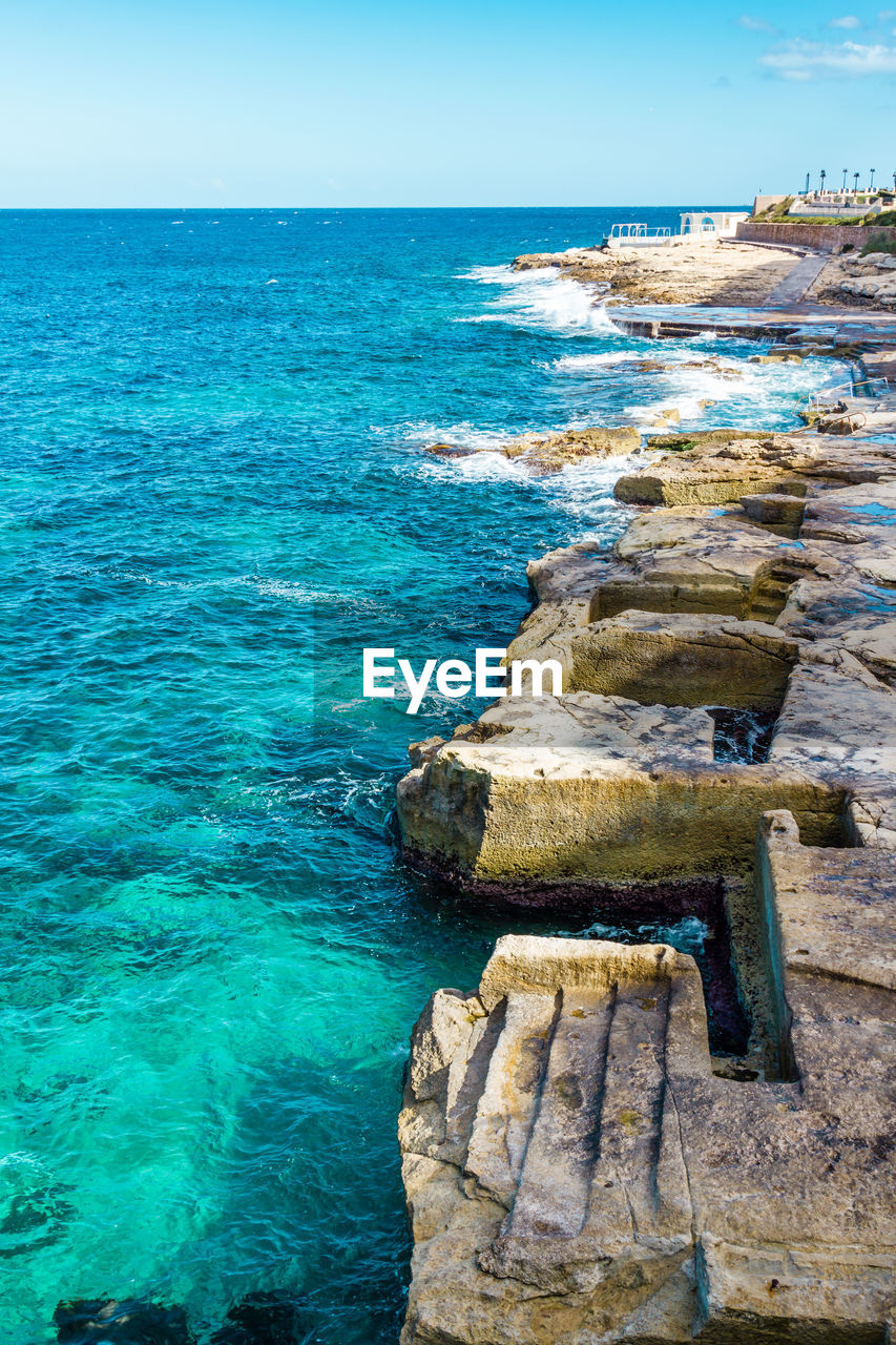 SCENIC VIEW OF SEA WITH ROCKS IN BACKGROUND