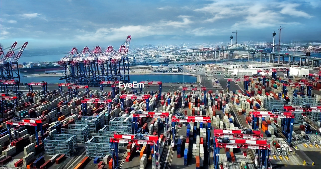 High angle view of commercial dock against sky in city