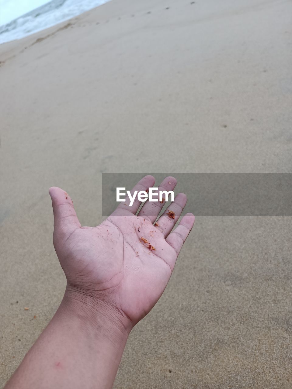 beach, sand, land, hand, human leg, one person, limb, sea, day, nature, finger, personal perspective, barefoot, leisure activity, water, lifestyles, human foot, arm, close-up, high angle view, outdoors, vacation, trip, holiday, adult, toe