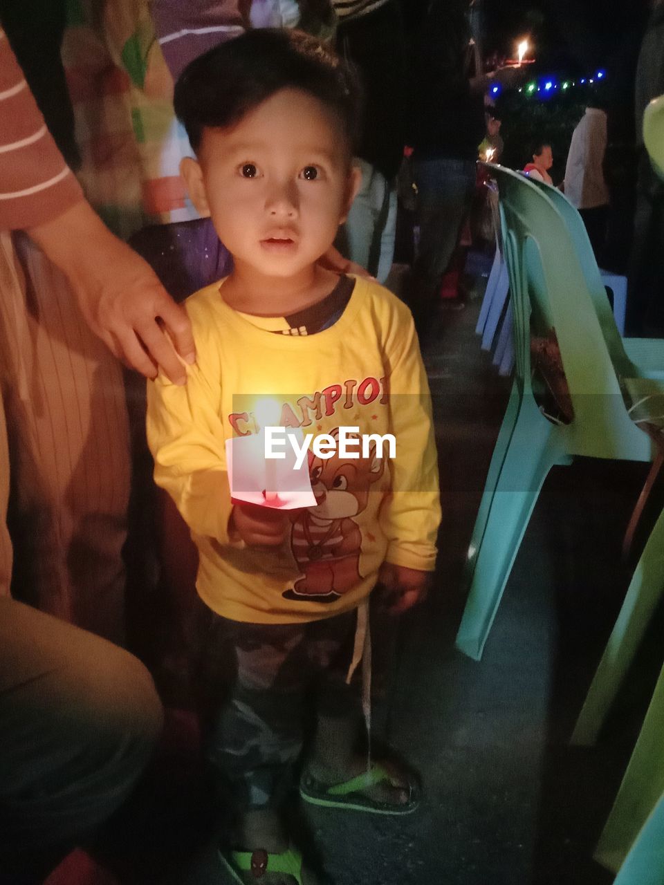 PORTRAIT OF CUTE BOY HOLDING ILLUMINATED CANDLES