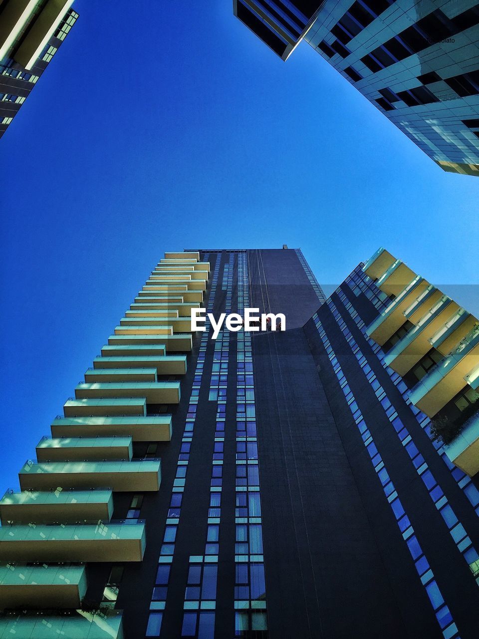 LOW ANGLE VIEW OF MODERN BUILDINGS AGAINST CLEAR SKY